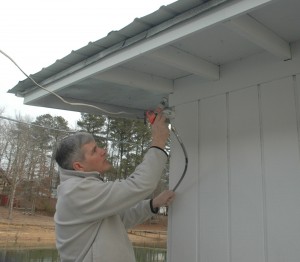 Spraying the eaves with the Milwaukee Tools airless paint system